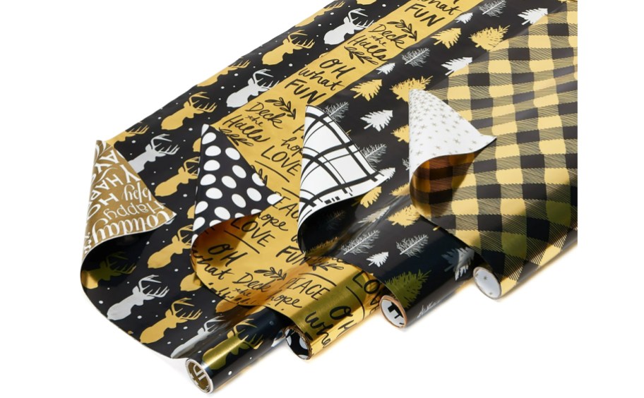 4 rolls of reversible black and gold christmas wrapping paper