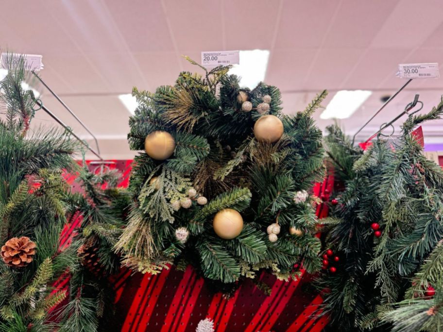 Decorated Mixed Pine Artificial Christmas Wreath on a store display wall