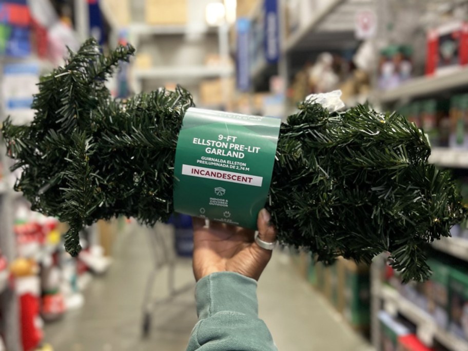 hand holding up a pre-lit garland strand