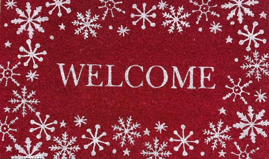 red welcome doormat with white snowflakes