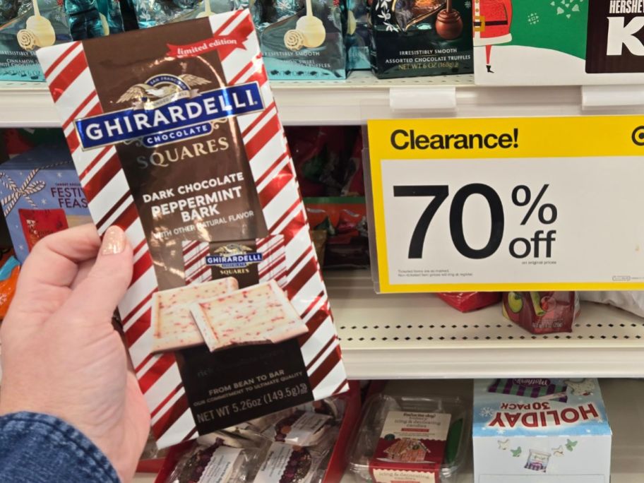 womans hand holding a bag of peppermint bark