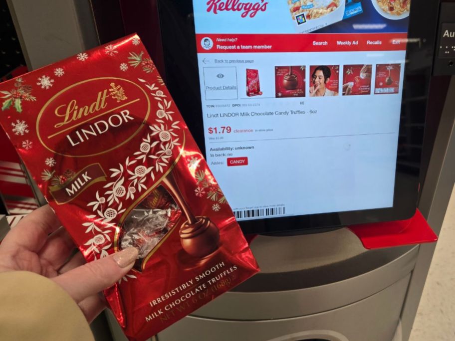 womans hand holding a bag of milk chocolate truffles