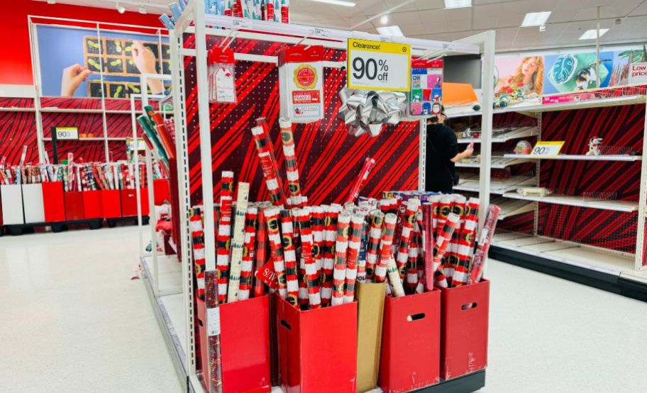 bins of wrapping paper rolls on a store aisle marked for clearance