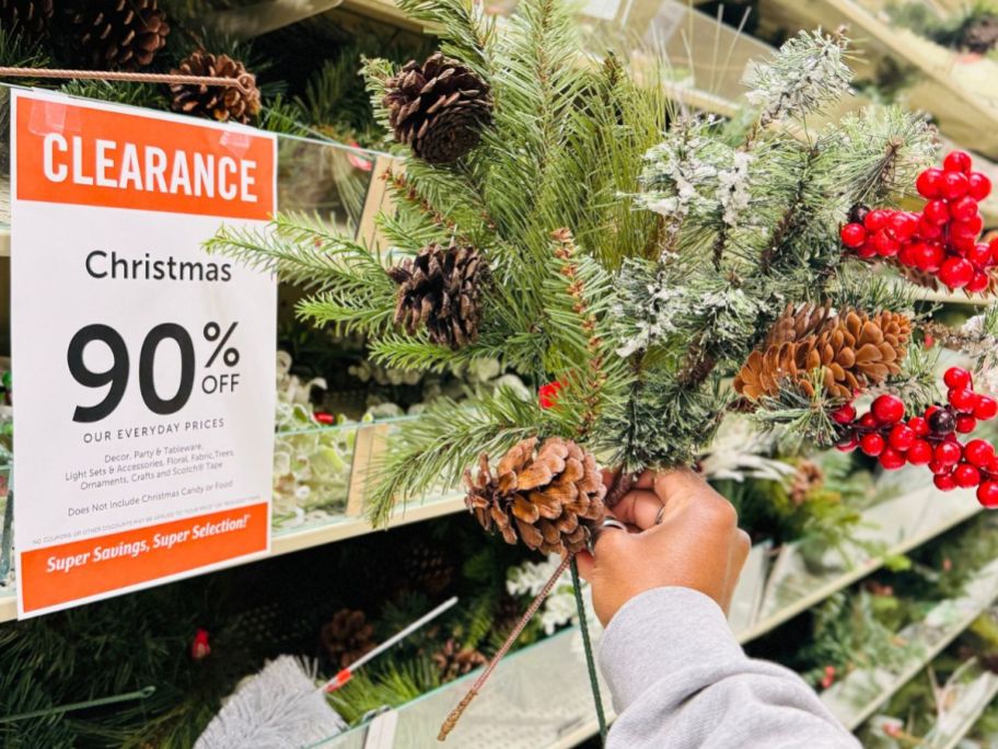 Hand holding a holiday floral pick