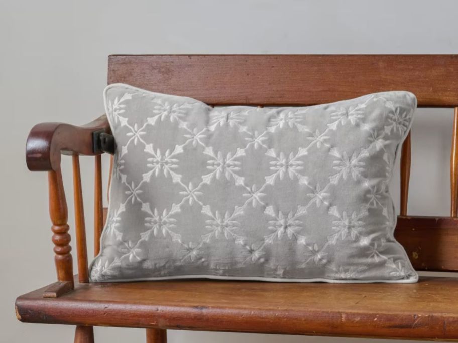 Magnolia Aurora Embroidered Velvet Lumbar Pillow on bench