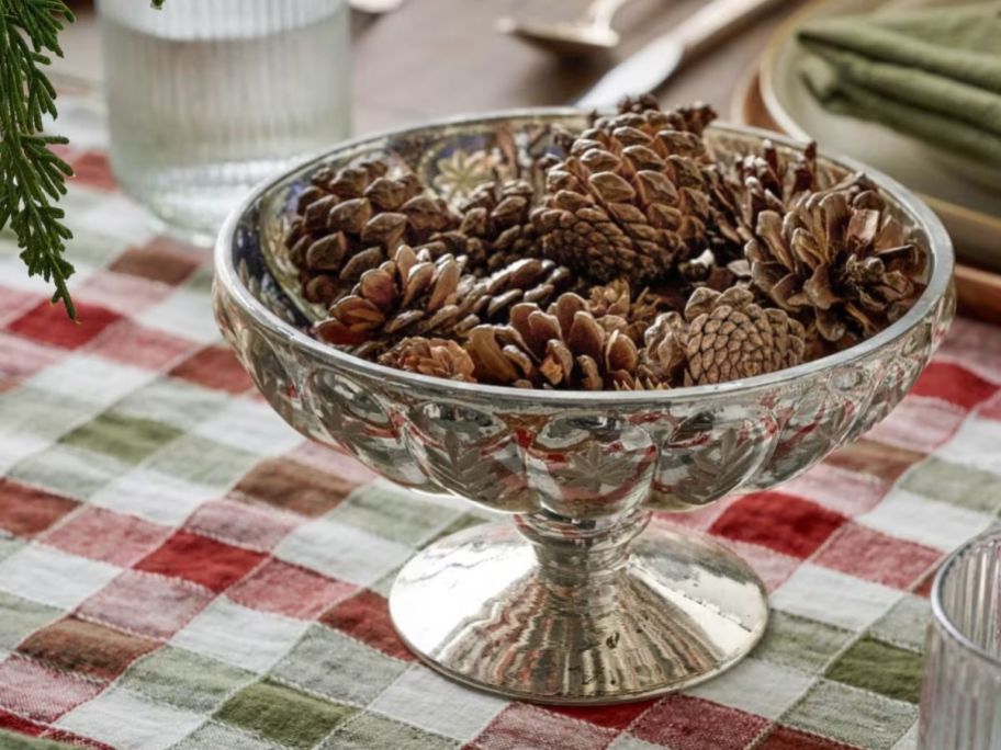 Magnolia Etched Mercury Glass Compote Bowl on table with pinecones in it