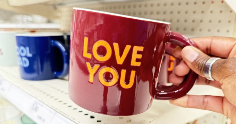 hand holding a red mug that says "Love You"