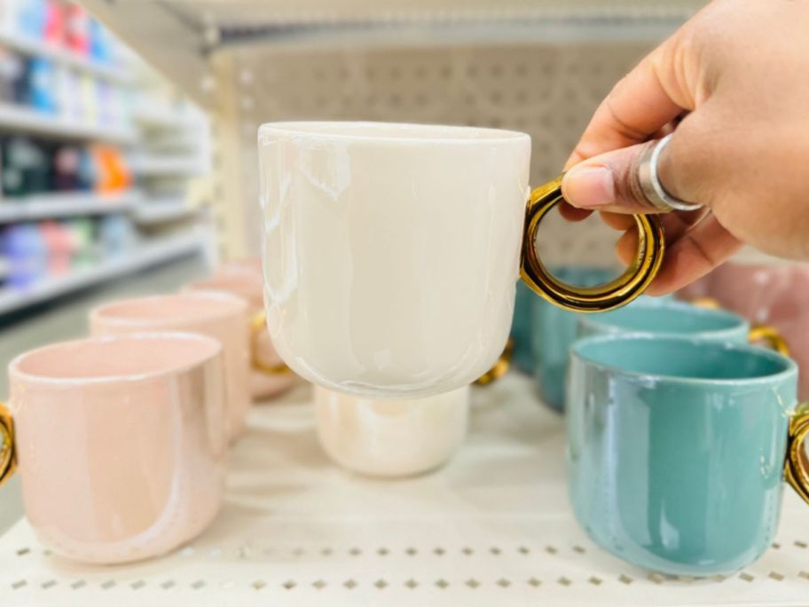 hand holding a Threshold 14.66oz Stoneware Pearlized Glaze Mug w/ Gold Handle 