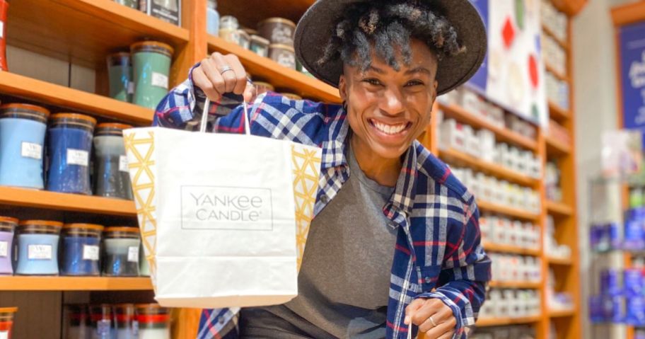 Woman holding a Yankee Candle Bag