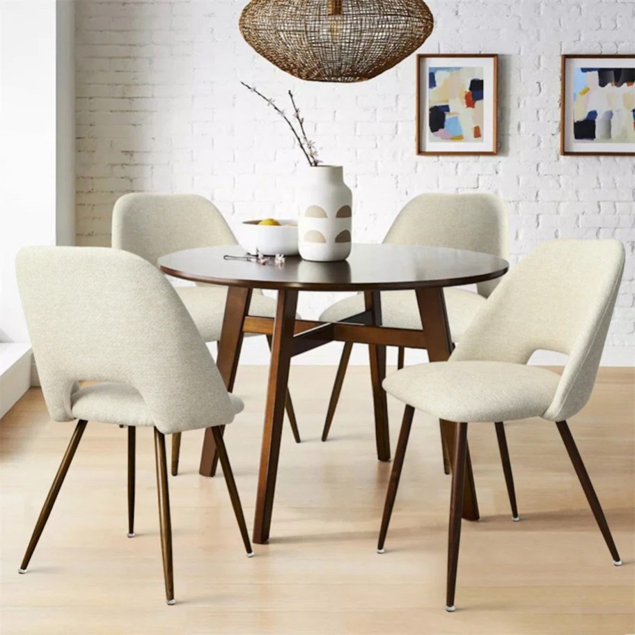 white dining chairs around wood table