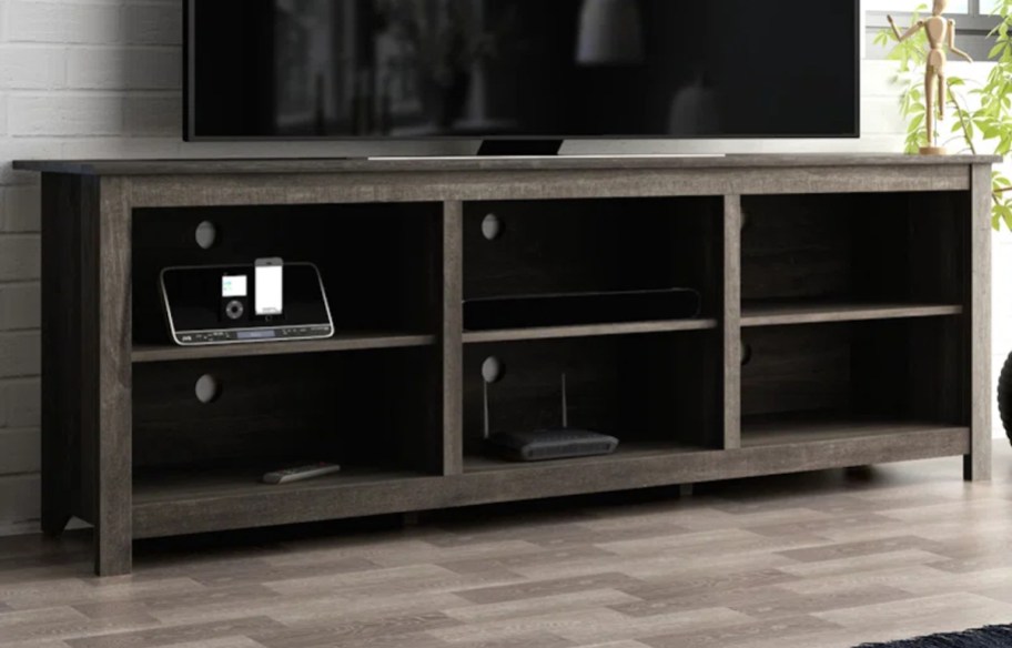 dark brown tv console stand table with flat screen above it in living room