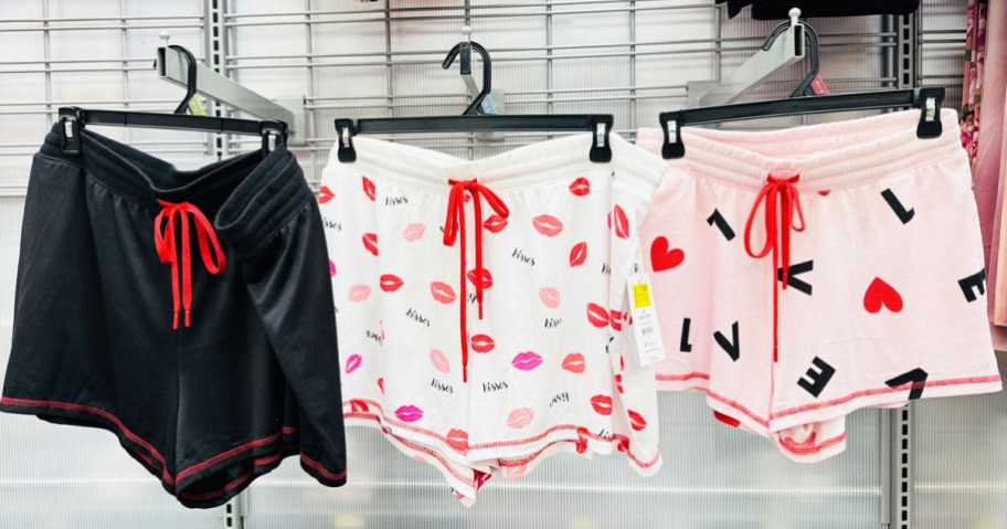 three pairs of sleep shorts hanging on store display