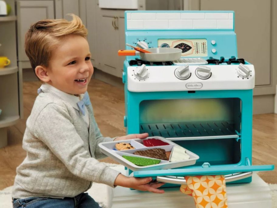 kid playing with Little Tikes Retro '50s Inspired Oven Realistic Pretend Play Kitchen Appliance