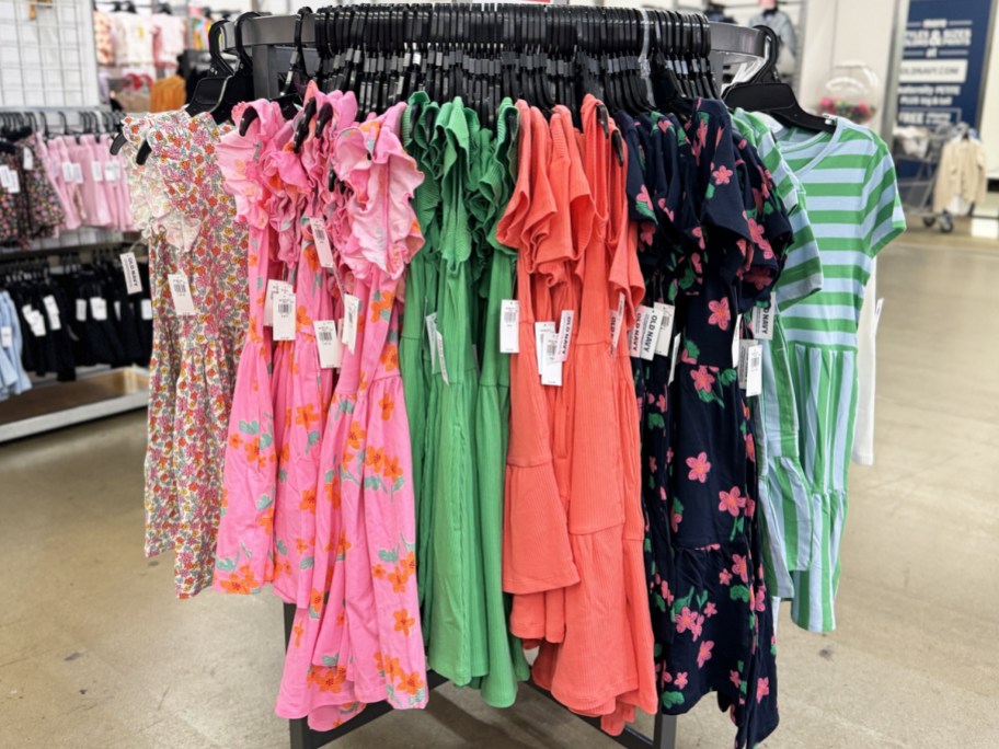 store display rack full of girls dresses on hangers