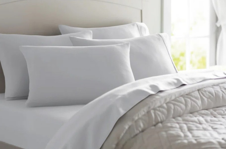 close up of bed with white sheets