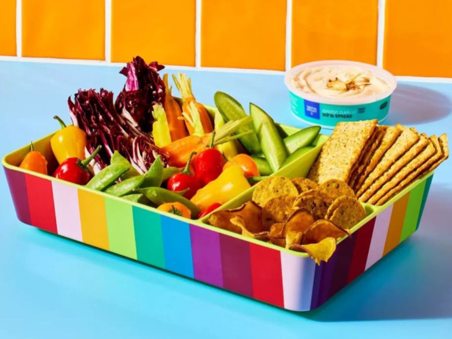 A Tabitha Brown Rainbow Family Snack Tray filld with fresh vegetables, crackers, and snack foods